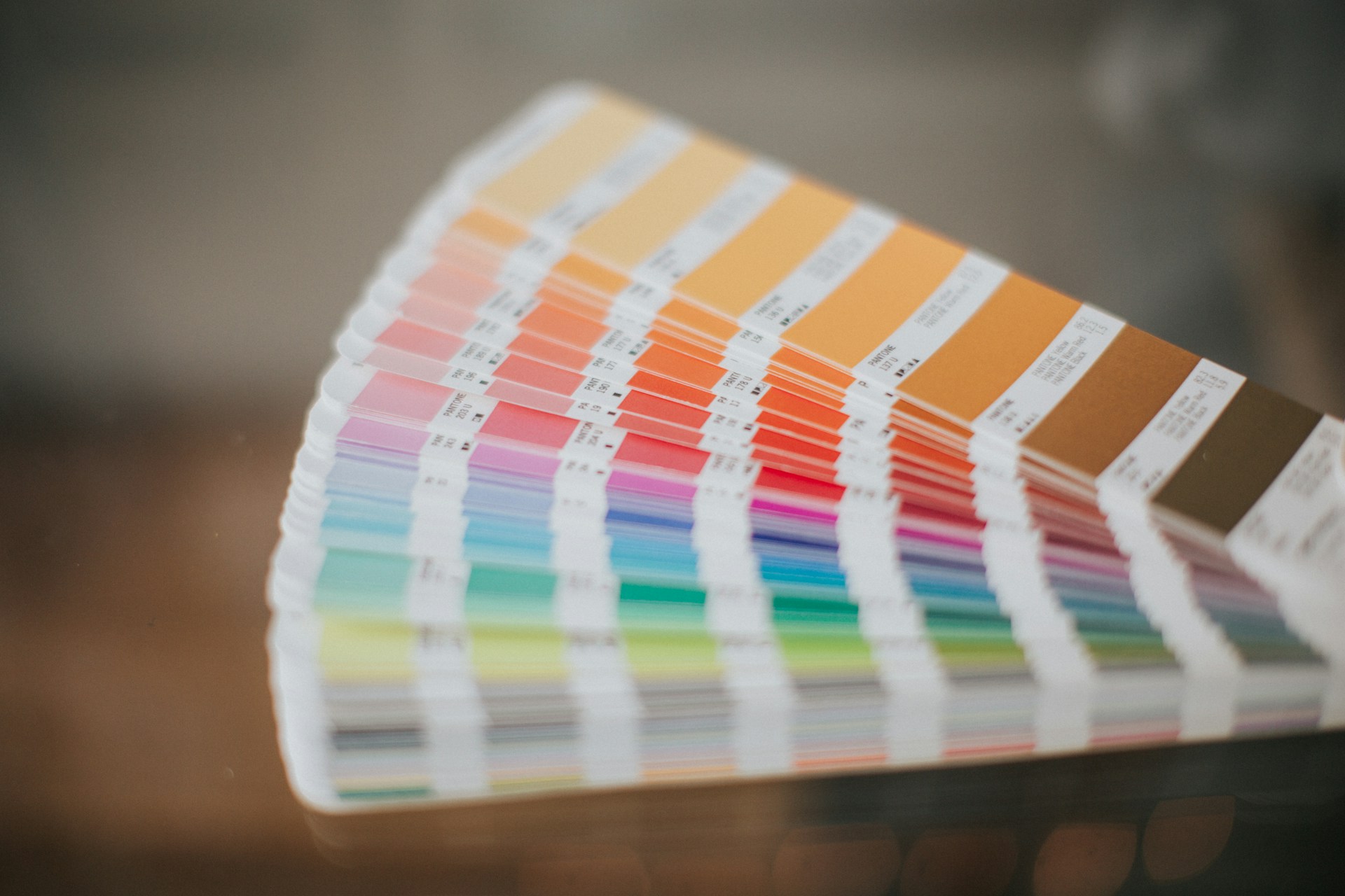 A photo of an extended fan of Pantone color swatches, used for color matching.
